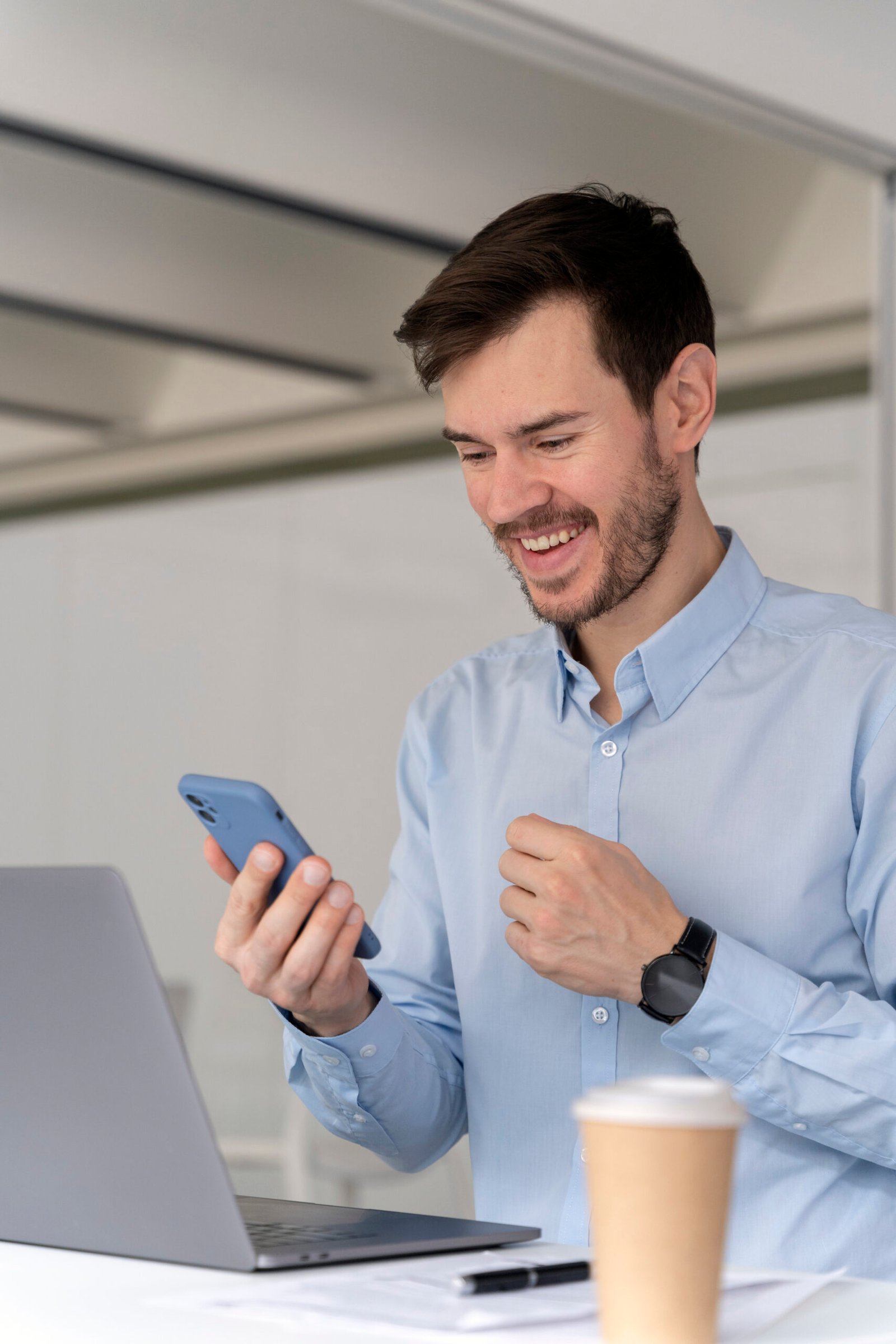 young-business-man-working-her-desk-with-laptop-smartphone
